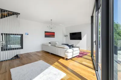a living room with a white couch and a tv at Luxury Penthouse Prague in Prague