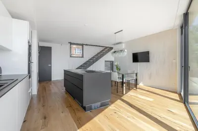 a kitchen and dining room with a table and a staircase at Luxury Penthouse Prague in Prague