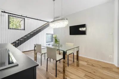 a dining room with a glass table and chairs at Luxury Penthouse Prague in Prague