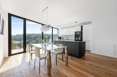 a kitchen and dining room with a table and chairs at Luxury Penthouse Prague in Prague
