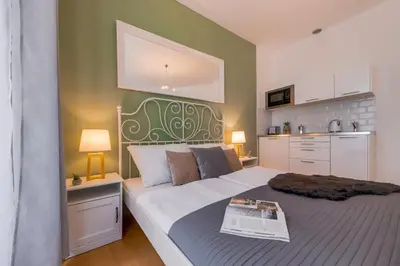 a bedroom with a large bed with a newspaper on it at King´s Road Residence in Prague