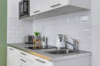 a kitchen with a sink and a counter top at King´s Road Residence in Prague