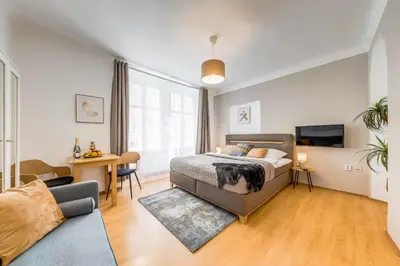 a bedroom with a bed and a living room at King´s Road Residence in Prague