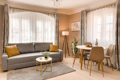 a living room with a couch and a table at King´s Road Residence in Prague