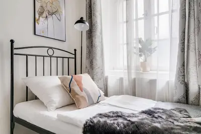 a bedroom with a bed and a window with a plant at King´s Road Residence in Prague