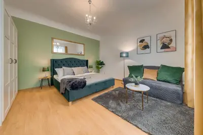 a living room with a bed and a couch at King´s Road Residence in Prague