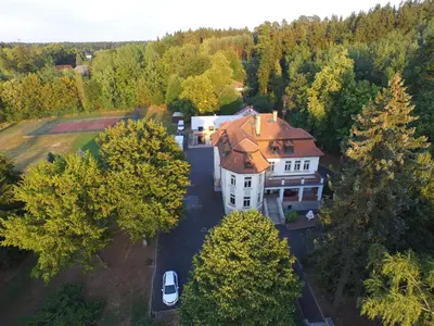 an aerial view of a large house with a red roof at Vila Olga in Jevany