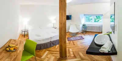 a room with a bed and a table with a bowl of fruit at Vila Olga in Jevany