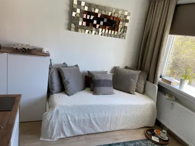 a bedroom with a bed with pillows and a window at DE LUXE Apartment, WIFI, TV 65