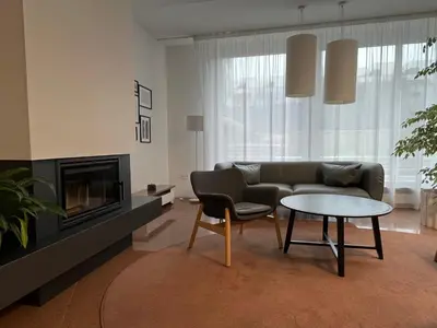 a living room with a couch and a table at DE LUXE Apartment, WIFI, TV 65