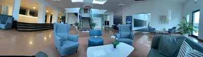 a lobby with blue chairs and a table in a building at DE LUXE Apartment, WIFI, TV 65