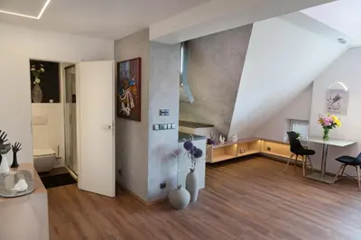 a living room with a table and vases on the floor at Apartmán 3kk - 115m2 v klidné lokalitě - Praha 4 in Prague