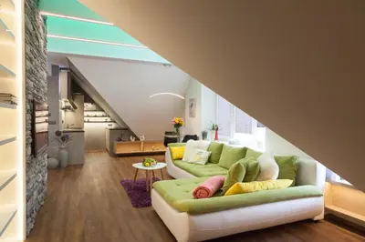 a living room with a green couch with pillows at Apartmán 3kk - 115m2 v klidné lokalitě - Praha 4 in Prague