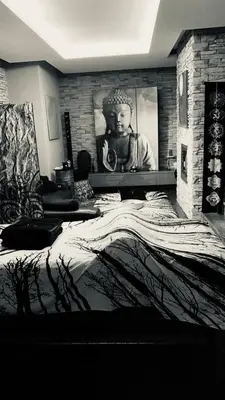 a bedroom with a large bed with a statue on the wall at Apartmán 2+kk, 50 m2 v klidné lokalitě. 10 min od centra Prahy. in Prague