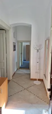 a hallway with a room with white walls and a floor at City center apartment Thomas No1 in Prague