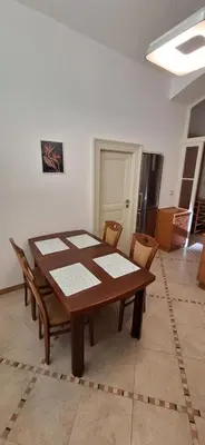 a wooden table and chairs in a room at City center apartment Thomas No1 in Prague