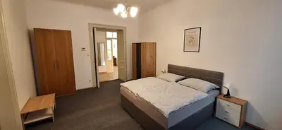 a bedroom with a bed and a dresser in it at City center apartment Thomas No1 in Prague