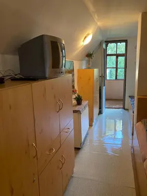 a kitchen with a television on top of a cabinet at Rekreační chata Hradištko in Hradištko