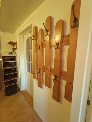 a bunch of wooden skateboards hanging on a wall at Zálesí in Prague