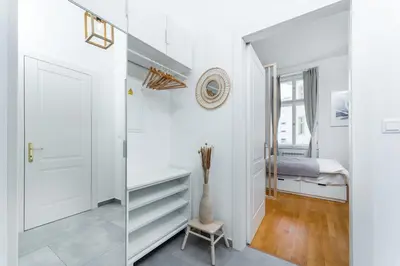 a bedroom with white walls and a desk and a bed at Anytime Holiday- Muzeum Apartments in Prague