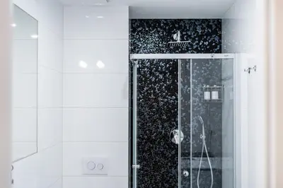 a shower with a glass door in a bathroom at Anytime Holiday- Muzeum Apartments in Prague