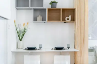 a small kitchen with a table and two chairs at Anytime Holiday- Muzeum Apartments in Prague