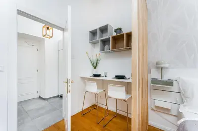 a small room with a desk and two chairs at Anytime Holiday- Muzeum Apartments in Prague