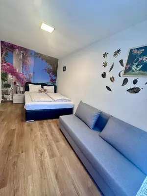 a bedroom with a bed and a couch in it at Cozy Sapa Stay - Private Apartment and Room in Prague