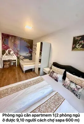 a bedroom with a large bed and a desk at Cozy Sapa Stay - Private Apartment and Room in Prague