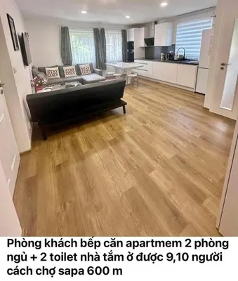 a living room with a couch and a kitchen at Cozy Sapa Stay - Private Apartment and Room in Prague
