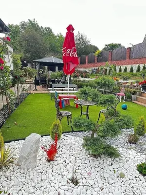 a garden with a table and a red umbrella at Cozy Sapa Stay - Private Apartment and Room in Prague
