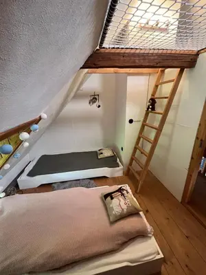 a room with two bunk beds and a ladder at Chaloupka v srdci Křivoklátska in Rakovník
