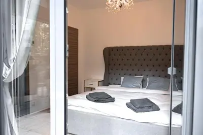 a bedroom with a bed and a glass door at Lovely Family Suite in Prague