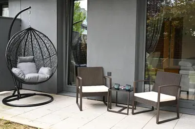 a porch with two chairs and a swing at Lovely Family Suite in Prague