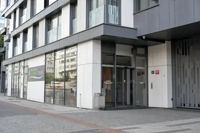 a building with glass doors on a city street at Lovely Family Suite in Prague