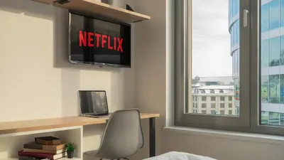 a room with a desk with a laptop and a window at MyMozart Residence by Rentez in Prague