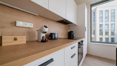 a kitchen with a counter top and a window at MyMozart Residence by Rentez in Prague
