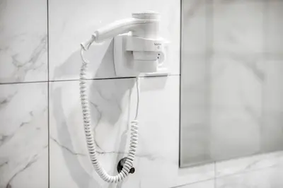 a white bathroom with a sink and a mirror at Villa Wagner in Prague