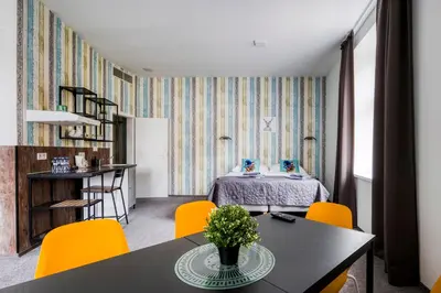 a bedroom with a bed and a desk in it at Villa Wagner in Prague