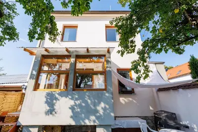 a house being built with a hammock in front of it at Entire house with garden near Prague in Benešov