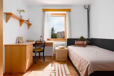 a bedroom with a bed and a desk and a window at Entire house with garden near Prague in Benešov