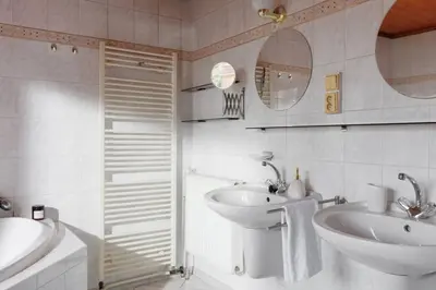 a bathroom with a sink and a toilet and a mirror at Entire house with garden near Prague in Benešov