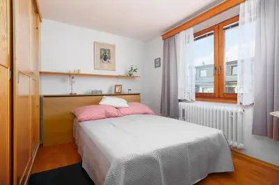 a bedroom with a bed with pink pillows and a window at Entire house with garden near Prague in Benešov