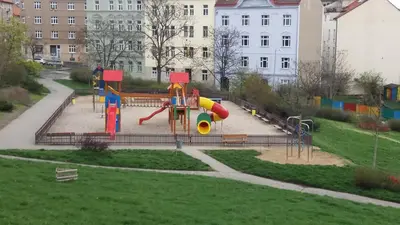 a playground with a slide in a park at Apartman Coral in Prague