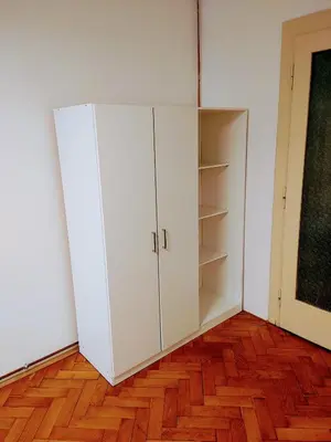 a white cabinet in a room with a wooden floor at Apartman Coral in Prague