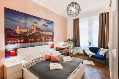 a bedroom with a large painting on the wall at ANGEL apartment Prague in Prague
