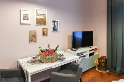 a room with a desk with a computer and a television at ANGEL apartment Prague in Prague