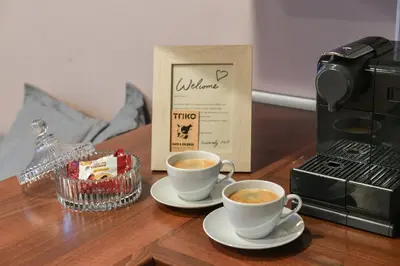 two cups of coffee on a table next to a microwave at ANGEL apartment Prague in Prague