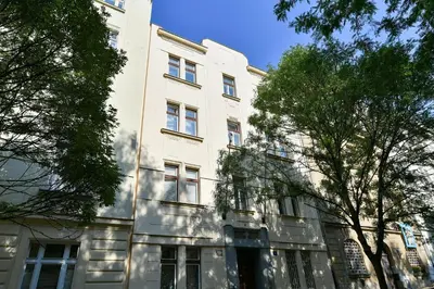 a white building with trees in front of it at ANGEL apartment Prague in Prague
