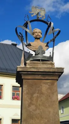 a statue on the top of a building with a sky at Apartmán Franz Josef in Hošťka
